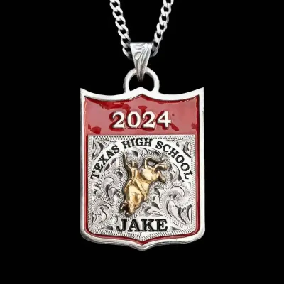A custom pendant necklace for graduations featuring a bull rider figure and custom lettering, with a sterling silver chain 
